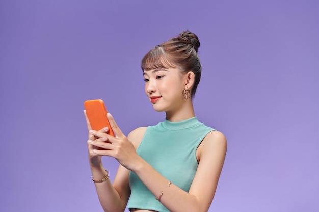 Smiling young woman girl posing isolated on purple pastel wall background studio portrait