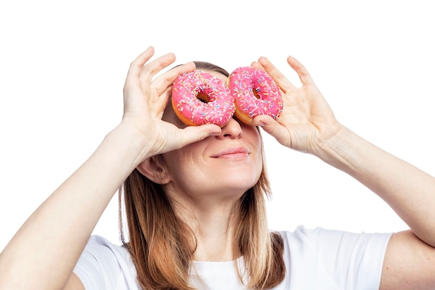 Smiling young woman holding donuts with pink icing Sweets and junk fast food Isolated on white background Closeup