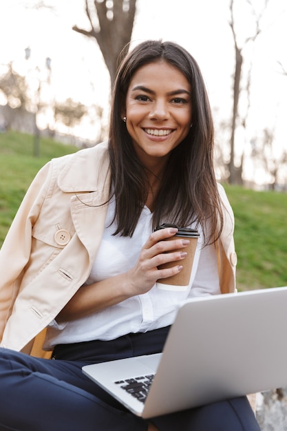 Smiling young woman using laptop computer