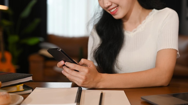 Smiling young woman using mobile phone for chatting with friends Technology social network communication concept