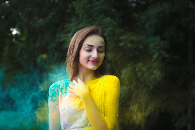 Smiling young woman with color powder on a Holi festival