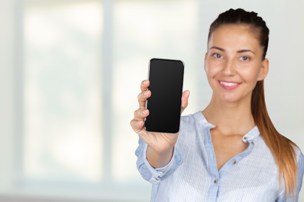 Smiling young woman with mobile phone