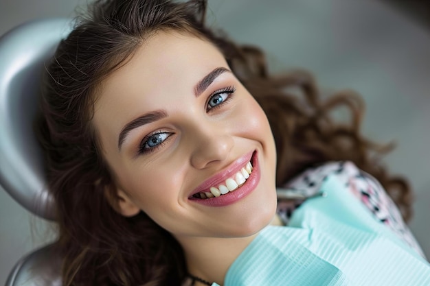 A smiling young woman with open mouth in a dental chair