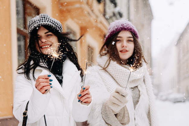 Smiling young women wearing warm winter clothing chatting