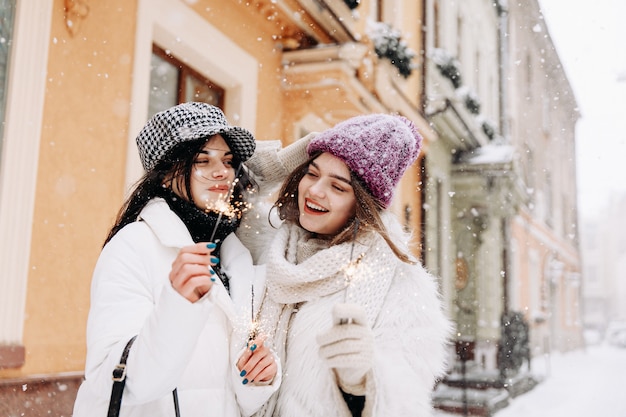 Smiling young women wearing warm winter clothing chatting