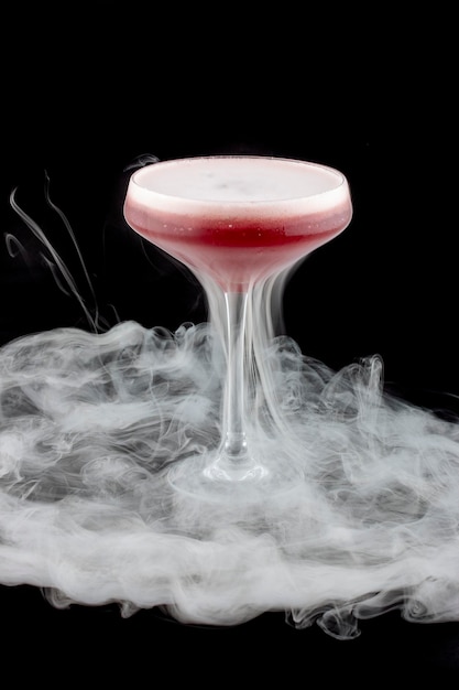 Smoke bubble strawberry cocktail on black background After bubble burst Isolated