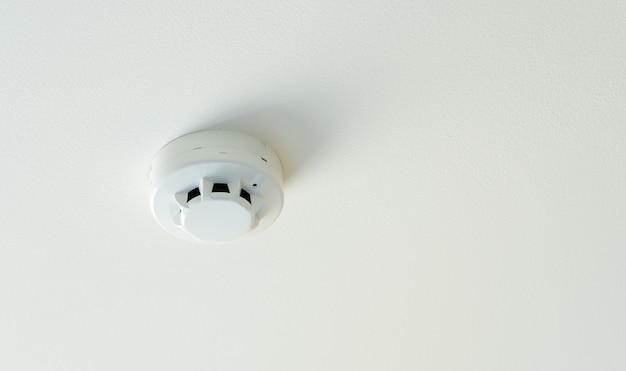 Smoke Detector mounted on the roof in hotel, fire alarm safety equipment in house