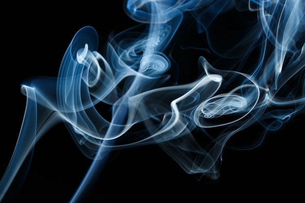 Smoke floating in the air on dark background