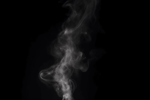 Smoke from a burning cigarette against a black background