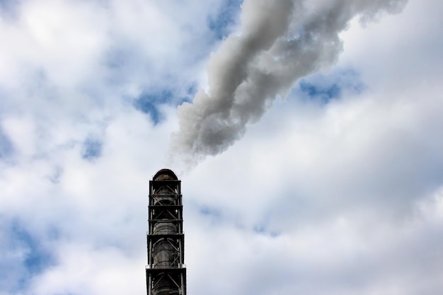 The smoke from the chimney of an industrial enterprise in the sky