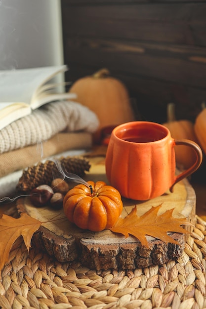 Smoke from an extinguished candle and a cup of tea autumn composition