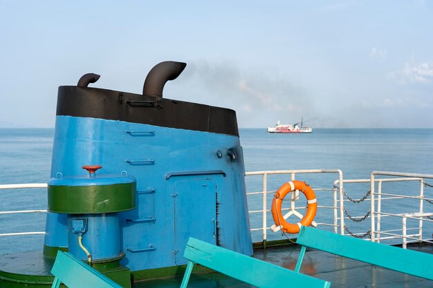 Smoke from ferry boat flue during sea with sunlight sea water and clear sky in background Thailand