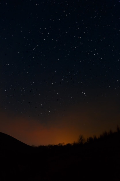 Smoke from a fire on a background of the night sky.