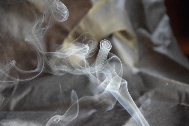 Smoke from a fragrant stick on a gray background