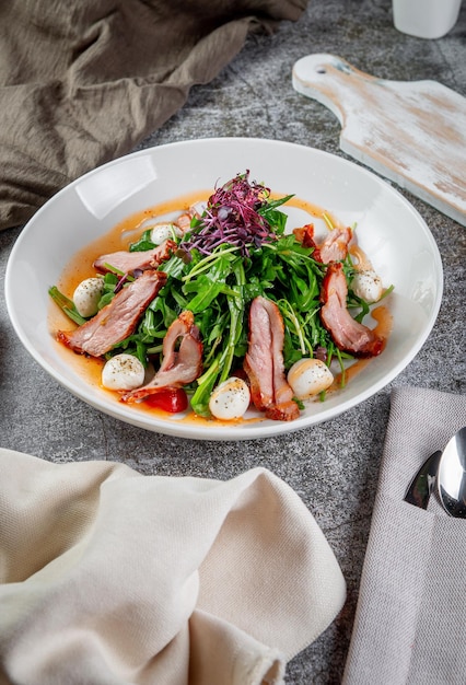 Smoked duck breast salad with vegetables and spices