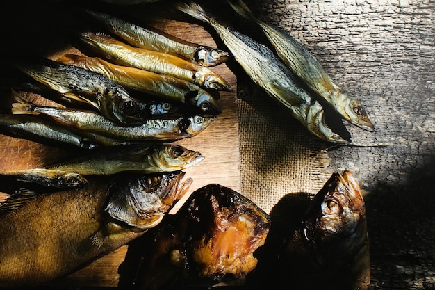 Smoked fish on wooden background