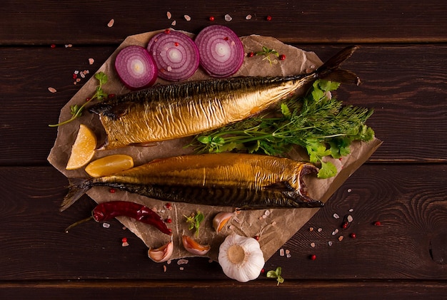 Smoked mackerel top view with spices on a wooden table no people selective focus