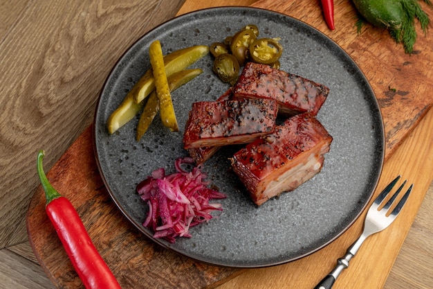 Smoked meat with pickled cabbage and pickled cucumbers