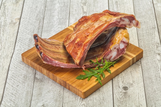 Smoked pork ribs over the wooden background