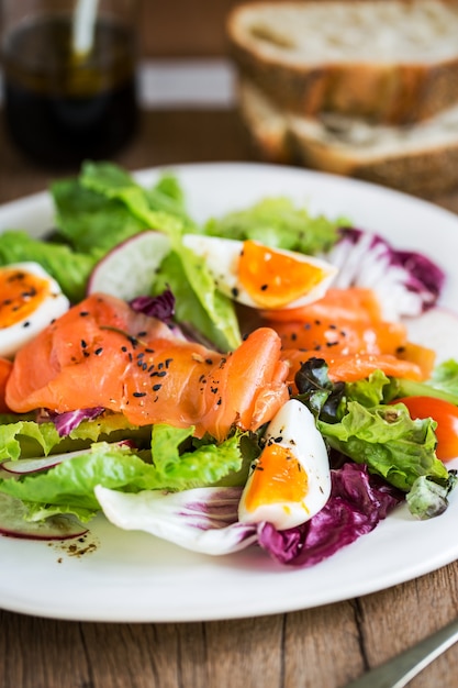 Smoked Salmon with boiled eggs salad by some bread