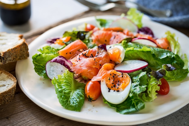 Smoked Salmon with boiled eggs salad by some bread