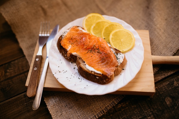 Smoked salmon with cheese toasted bread lemon and yogurt dip