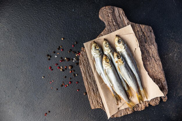 Smoked sprat fish herring salted seafood meal food snack on the table copy space food background