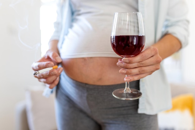 Smoking and alcohol pregnancywoman on a long pregnancy drinking alcohol and Smoking cigarettesproblems of alcoholism and the period of bearing a childdanger of losing a baby miscarriage alcoholic