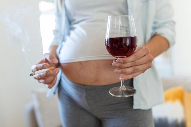 Smoking and alcohol pregnancywoman on a long pregnancy drinking alcohol and Smoking cigarettesproblems of alcoholism and the period of bearing a childdanger of losing a baby miscarriage alcoholic