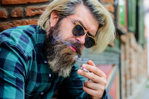 Smoking man. Sensual bearded hipster with cigarette. Bearded man smoke cigarette.