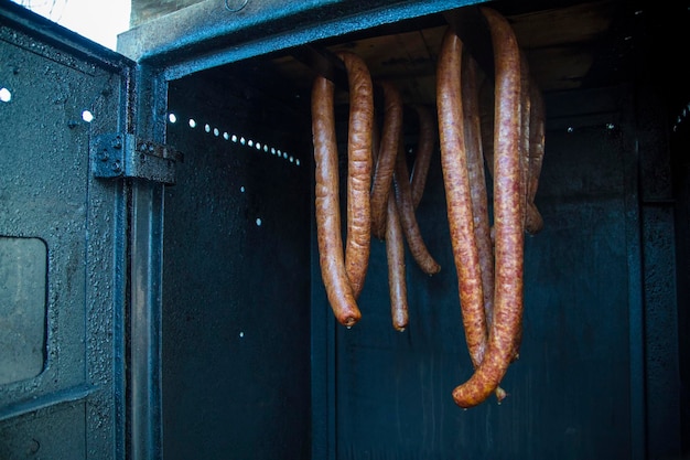 smoking sausage in a smokehouse