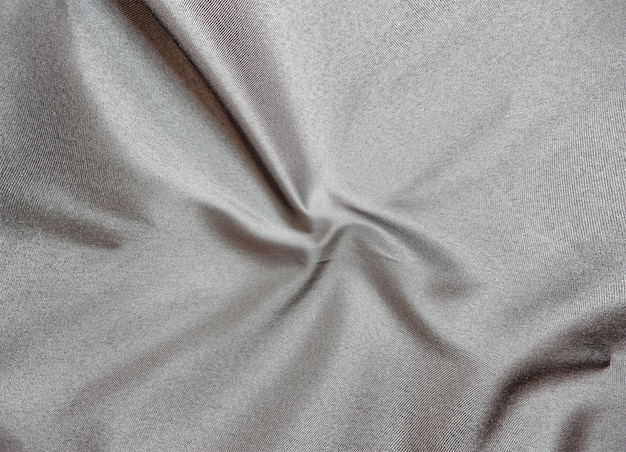 Smooth elegant black silk fabric or satin luxury cloth texture for abstract background