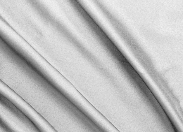 Smooth elegant black silk fabric or satin luxury cloth texture for abstract background