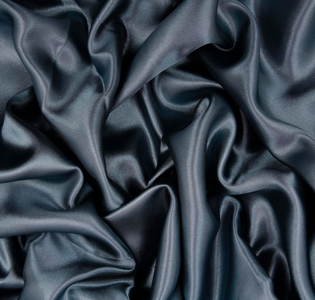 Smooth elegant dark grey silk or satin texture as abstract background Luxurious background design