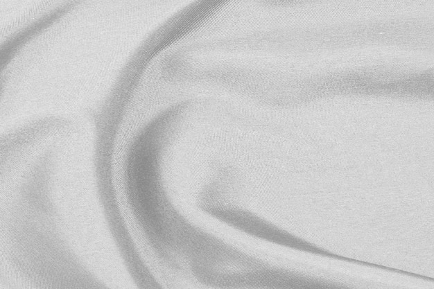 Smooth elegant white silk fabric or satin luxury cloth texture for drapery luxurious abstract design background