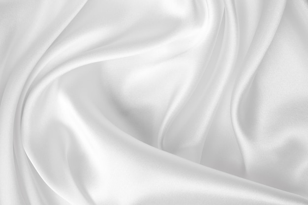 Smooth elegant white silk or satin luxury cloth texture can use as wedding background luxurious back