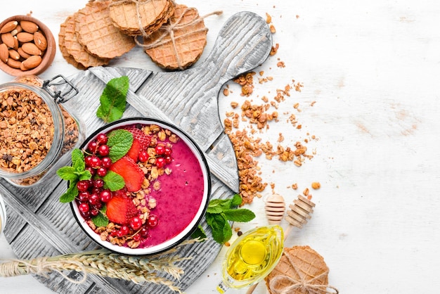 Smoothie bowl with granola strawberry red currants and mint Breakfast Top view Free space for your text