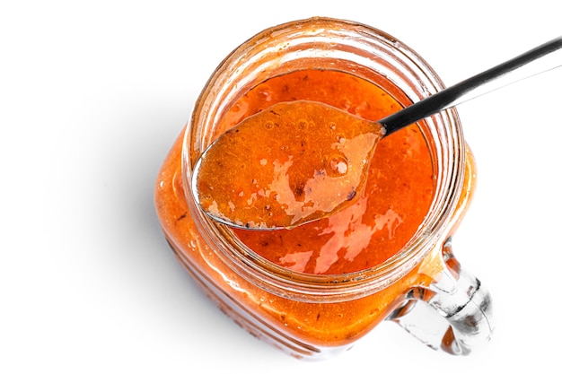 Smoothie with persimmon and banana in Mason jar on a white background