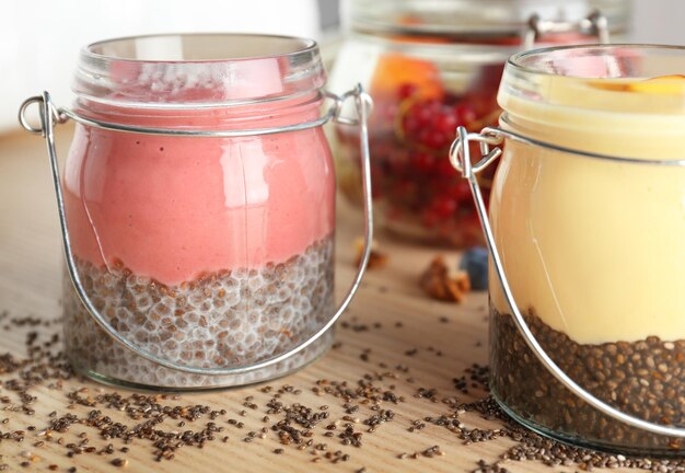 Smoothies with chia seeds in jars on table