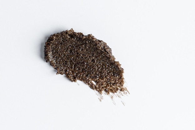 A smudge swatch smear of the brown coffee body scrub Texture background Product presentation marketing