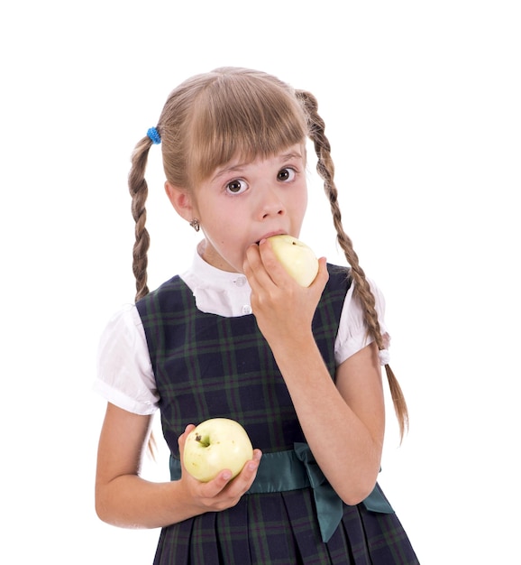 Snack Schoolgirl eats apples The little schoolgirl looks good in her school uniform A pretty schoolgirl with long dark hair and a charming look