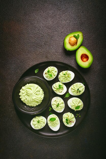 Photo snack stuffed eggs with avocado homemade no people