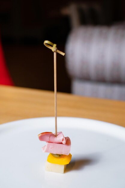 Snack with salami pepper and olive on a skewer