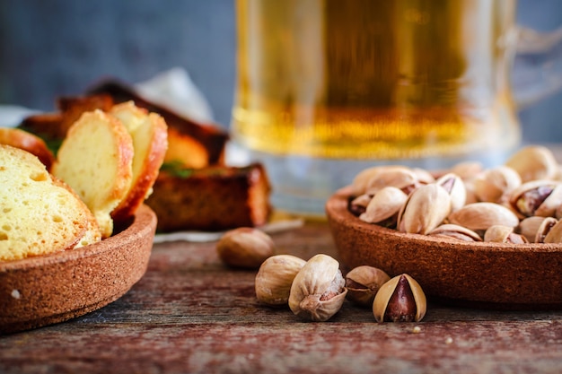 Snacks to beer, pistachios, rusks with dill and a mug of light beer