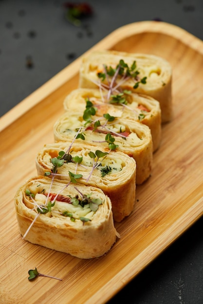 Snacks of pita bread with cheese and tomatoes Variety mix of small sandwiches on dark background Photo for restaurant menu