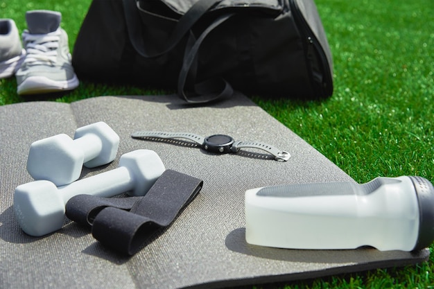 Sneakers and sport items on gray background top view