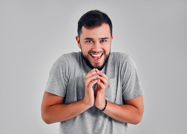 Sneaky scheming man trying to plot something isolated on gray background. Negative human emotion facial expression feeling