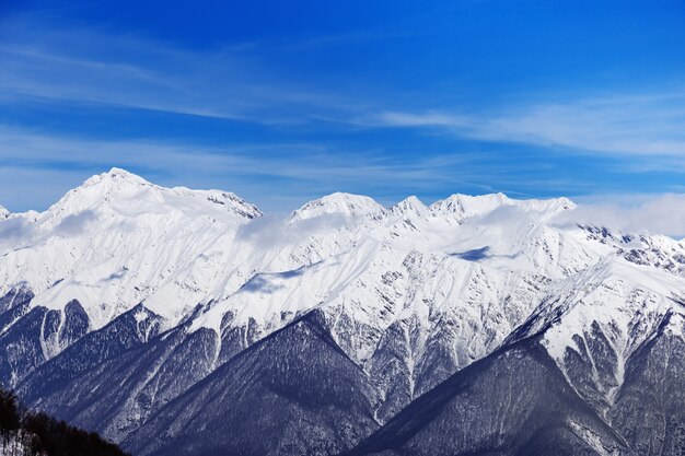 Snow-capped peaks of Caucasus mountain range.  Beautiful Views of ski resort of Rosa Khutorin. Winter landscape with blue sky.