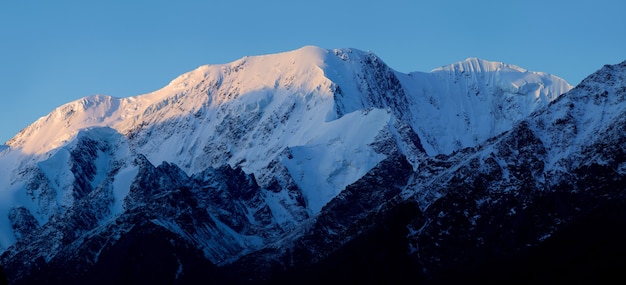 Snow-capped peaks in the light of the rising sun