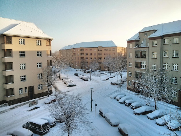 Snow covered buildings in city